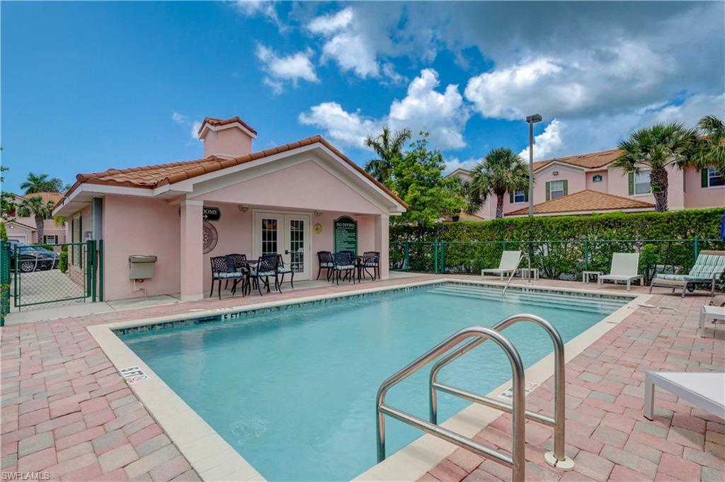990 Peggy Circle, Unit 404 Naples, FL 34113 - Photo 25 of 26 a view of a swimming pool with a patio