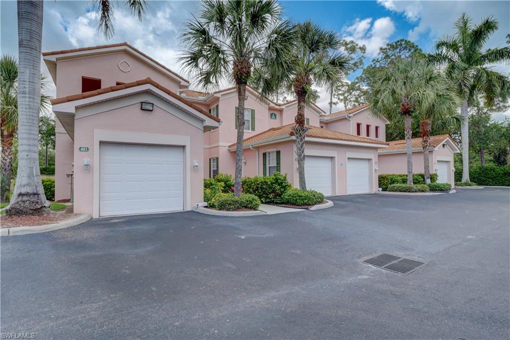 990 Peggy Circle, Unit 404 Naples, FL 34113 - Photo 26 of 26 a front view of a house with a yard and garage