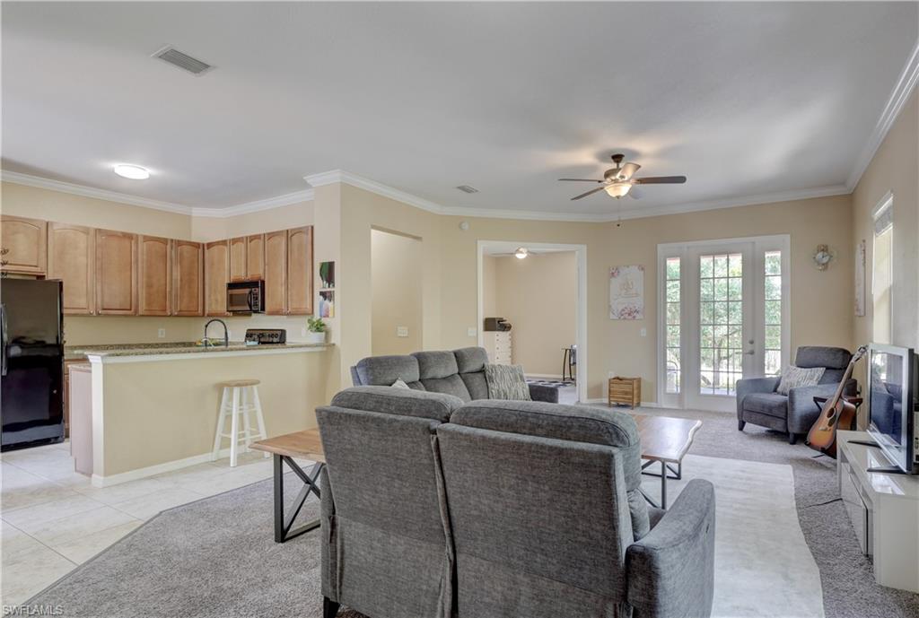990 Peggy Circle, Unit 404 Naples, FL 34113 - Photo 4 of 26 a living room with furniture a dining table and chairs