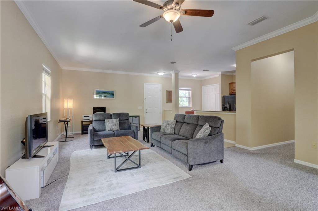 990 Peggy Circle, Unit 404 Naples, FL 34113 - Photo 5 of 26 a living room with furniture and a flat screen tv