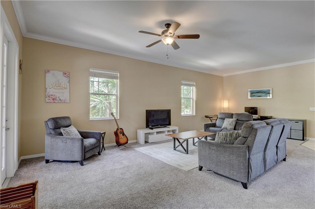 990 Peggy Circle, Unit 404 Naples, FL 34113 - Photo 6 of 26 a living room with furniture and a flat screen tv
