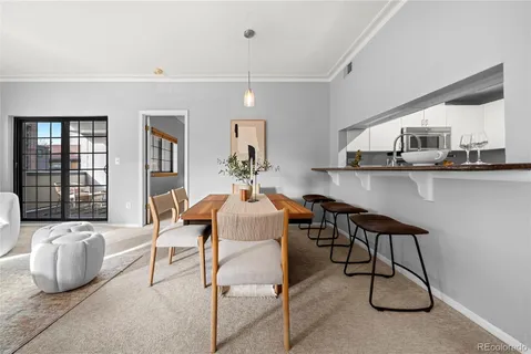 a dining room with furniture and window