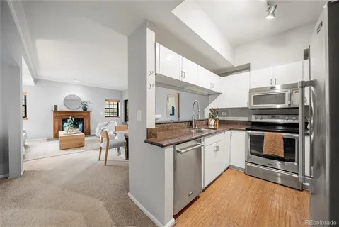 a kitchen with stainless steel appliances granite countertop a stove and a sink