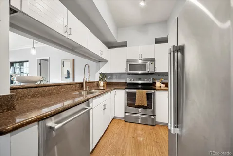 a kitchen with stainless steel appliances granite countertop a stove and a sink