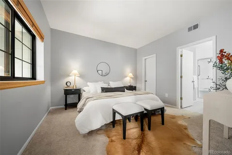 a bedroom with a bed and a table