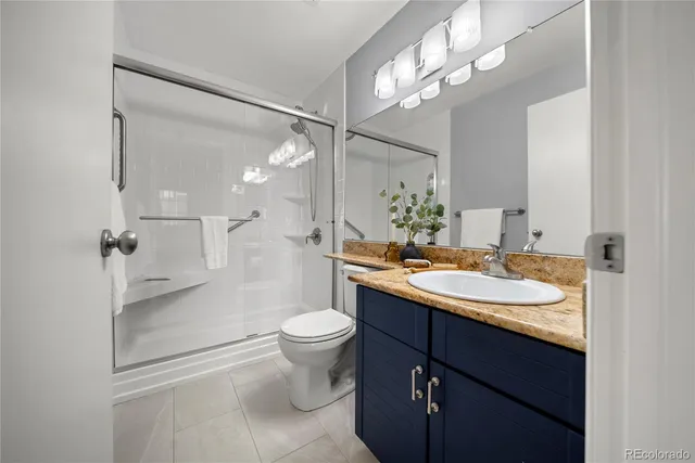 a bathroom with a sink toilet a mirror and shower