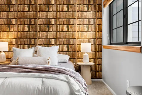 a bed room with a bed and a lamp