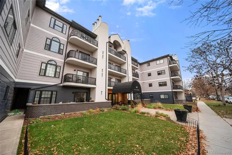 a front view of a building with a garden