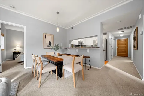 a view of a dining room with furniture and a view of kitchen