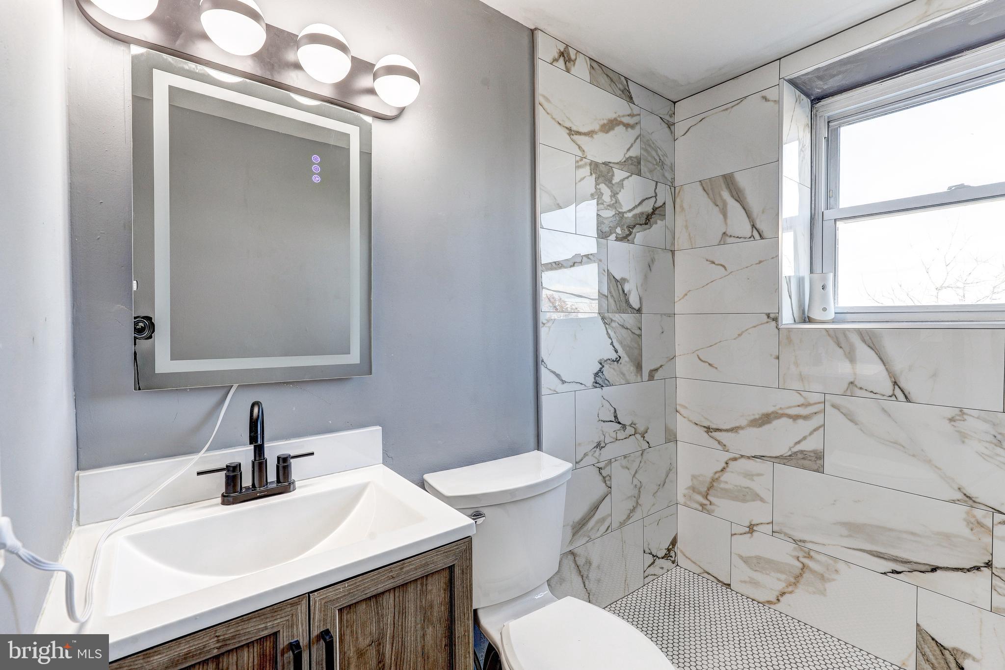 2707 Marbourne Avenue Baltimore, MD 21230 - Photo 12 of 14 a bathroom with a sink a toilet and shower