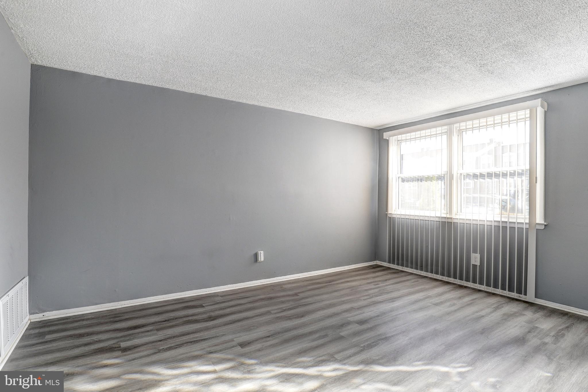 2707 Marbourne Avenue Baltimore, MD 21230 - Photo 5 of 14 wooden floor in an empty room with a window