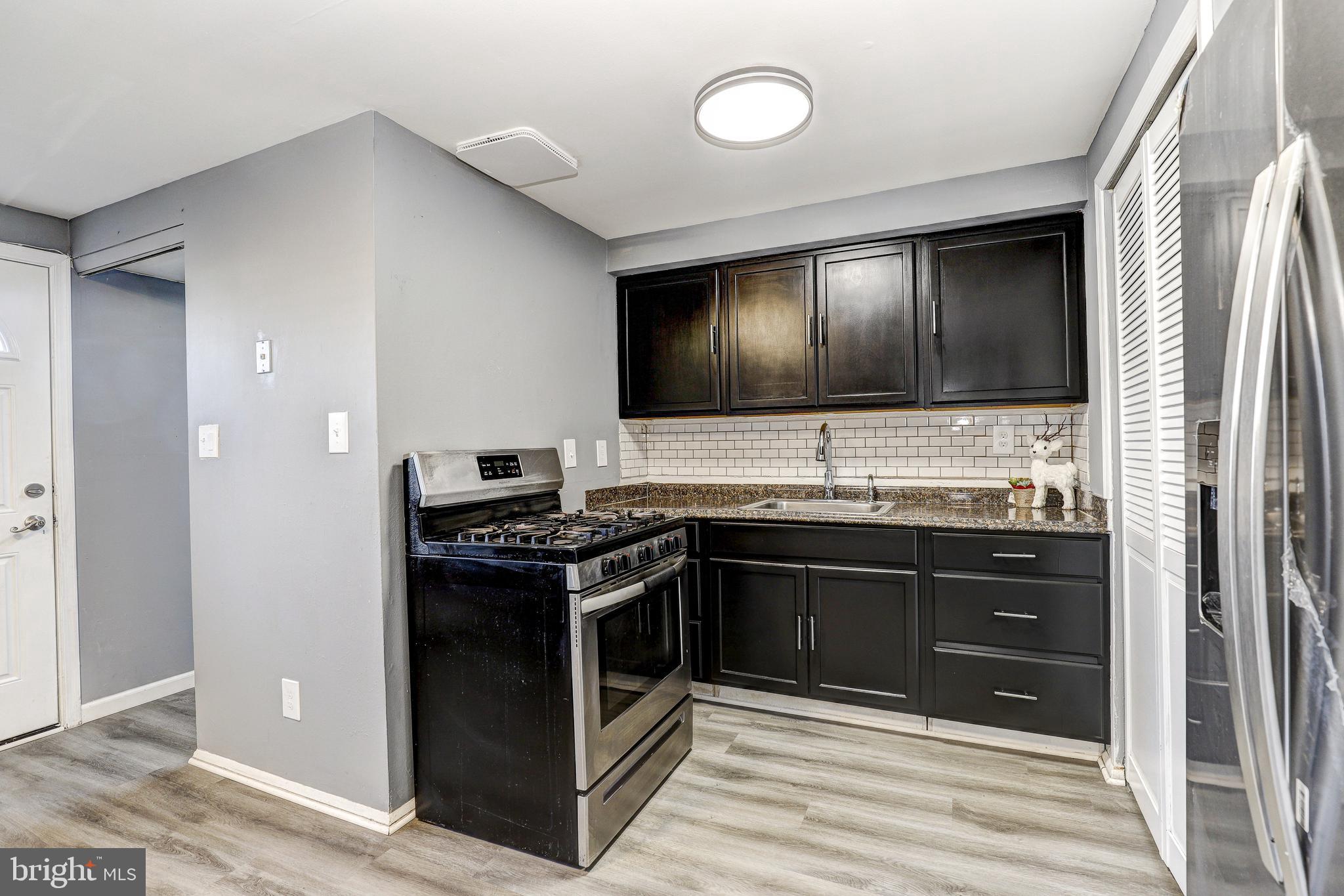 2707 Marbourne Avenue Baltimore, MD 21230 - Photo 7 of 14 a kitchen with stainless steel appliances granite countertop a stove and a sink
