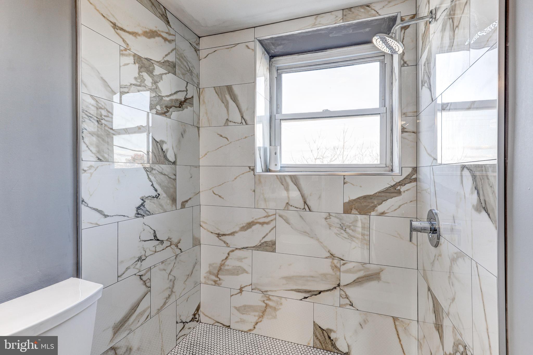2707 Marbourne Avenue Baltimore, MD 21230 - Photo 10 of 14 a bathroom with a bathtub and next to a window