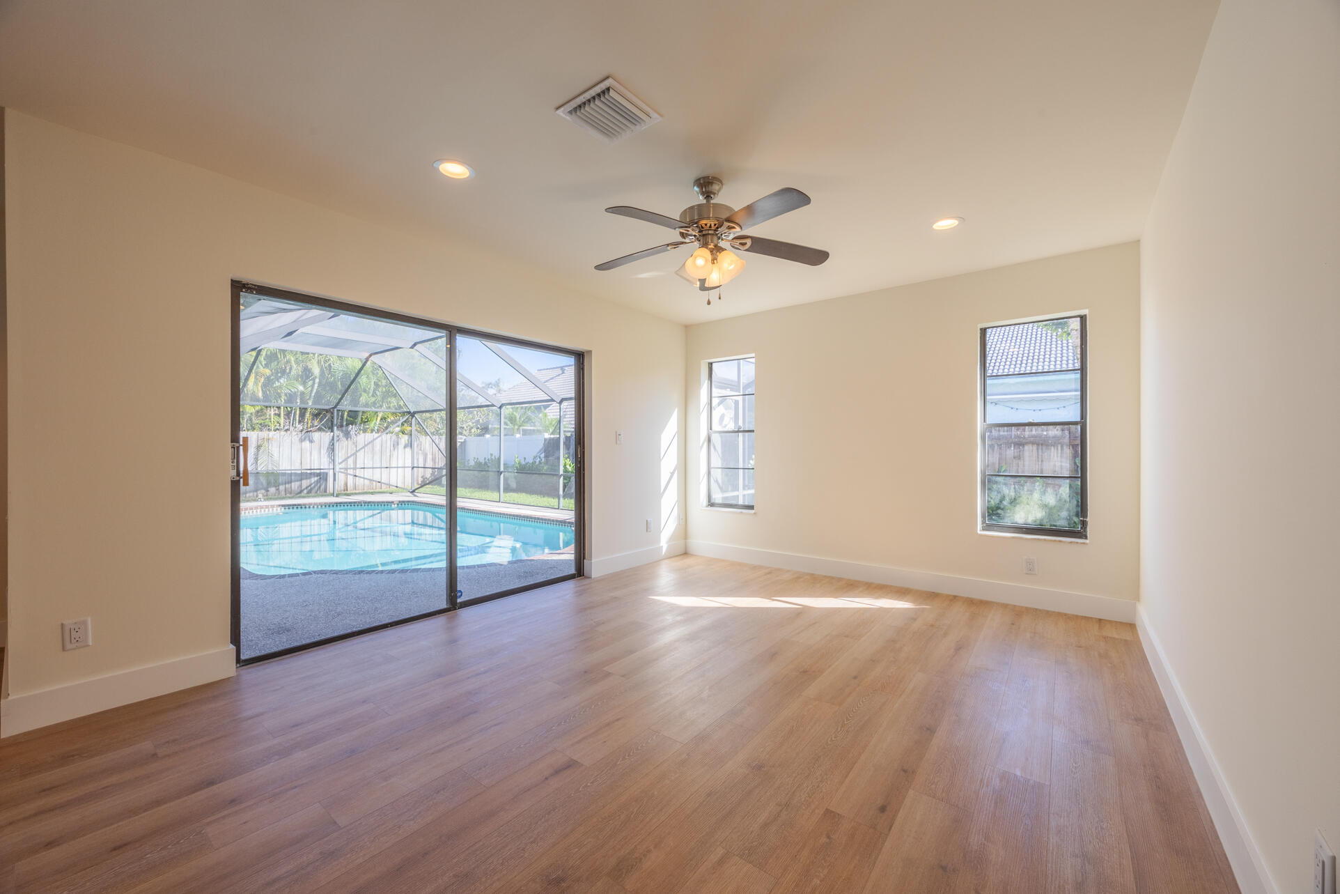 22352 Martella Avenue Boca Raton, FL 33433 - Photo 14 of 26 a view of an empty room with a window and wooden floor