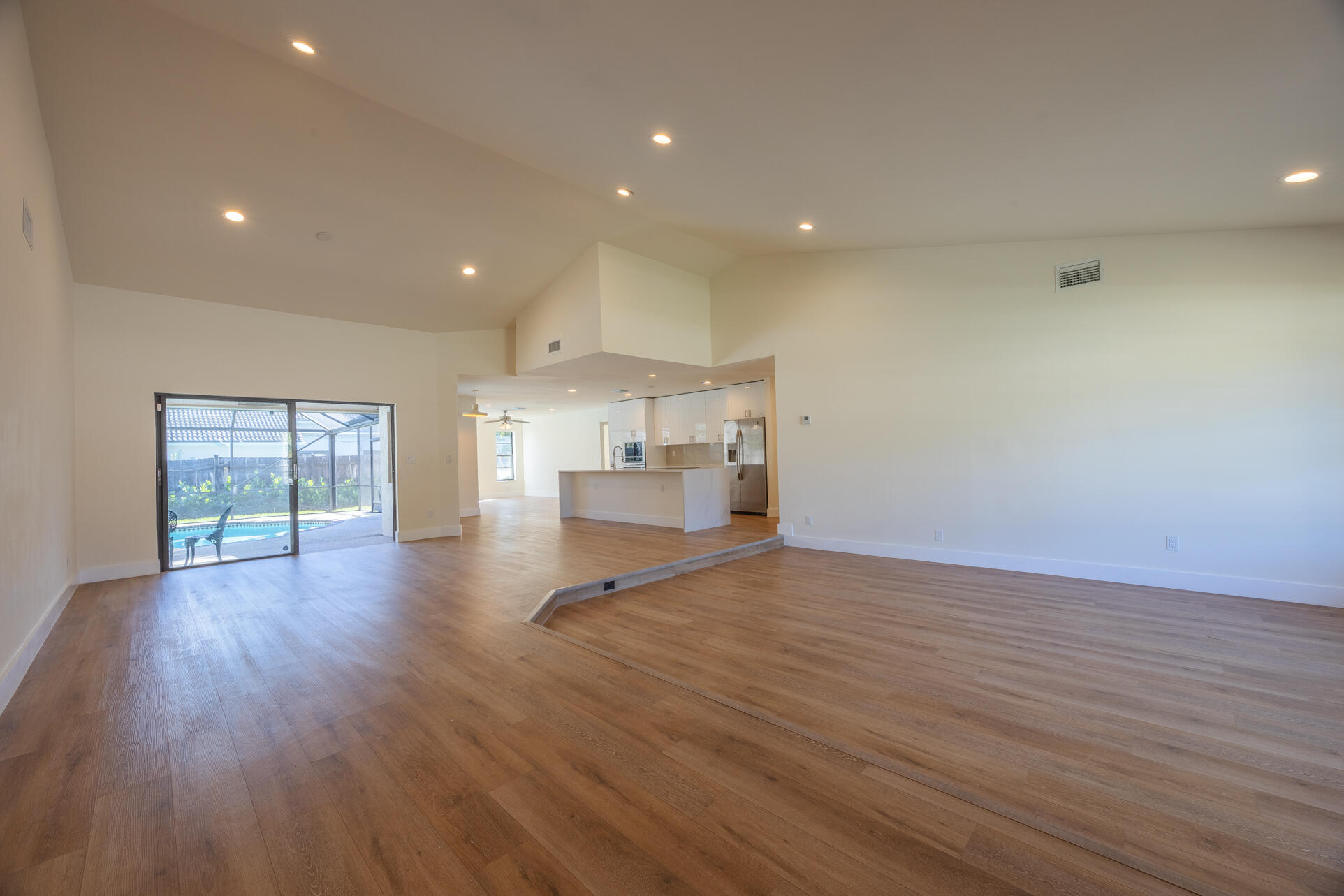 22352 Martella Avenue Boca Raton, FL 33433 - Photo 20 of 26 a view of empty room with wooden floor and windows
