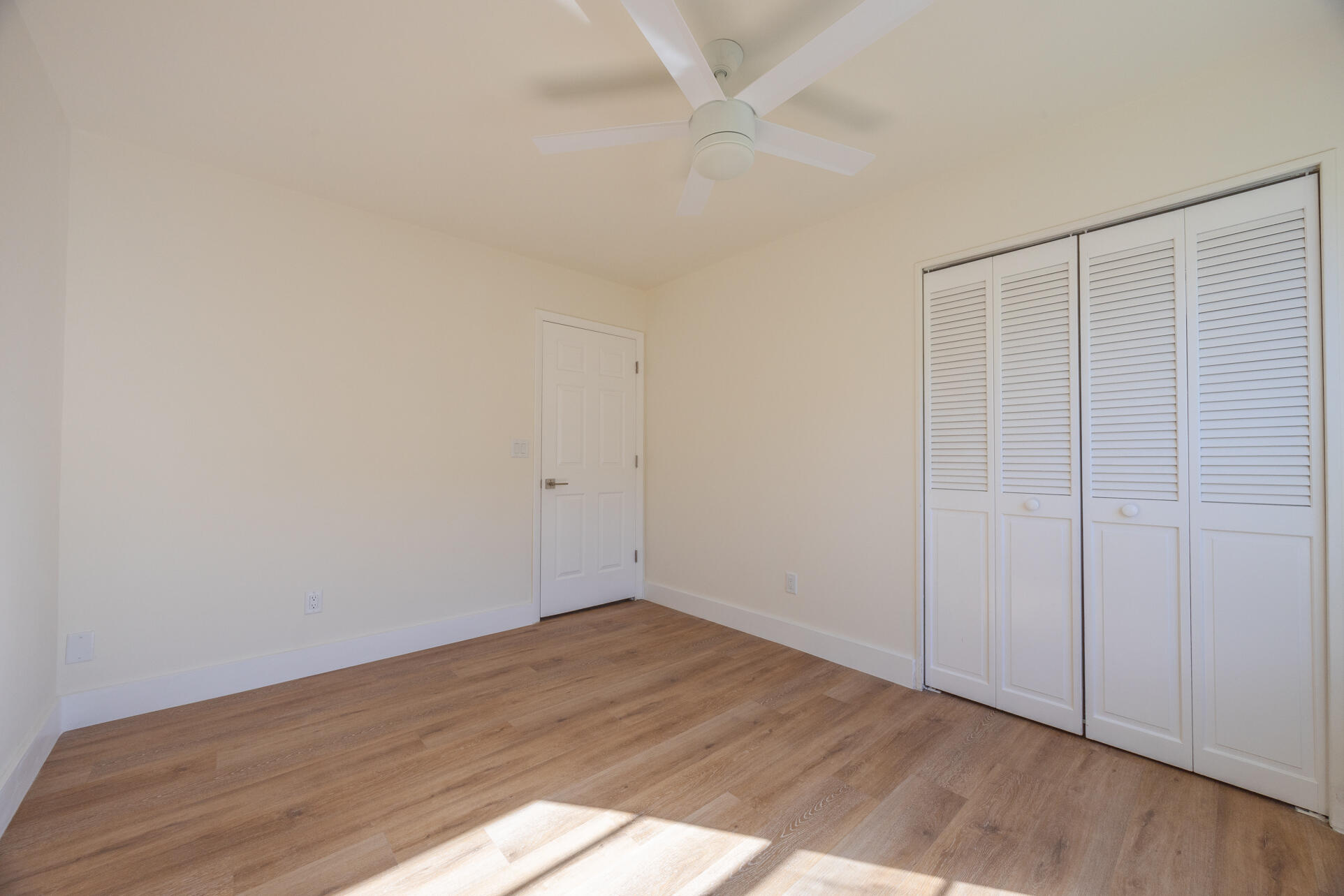 22352 Martella Avenue Boca Raton, FL 33433 - Photo 23 of 26 an empty room with wooden floor and windows
