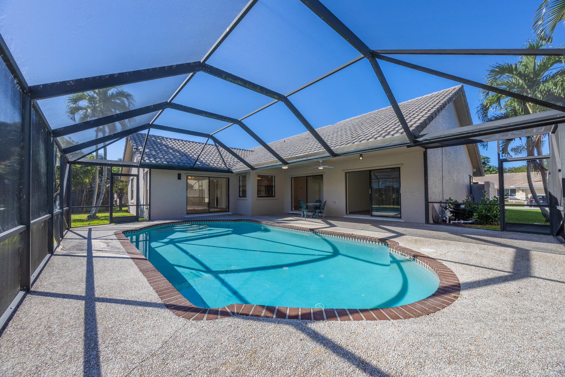 22352 Martella Avenue Boca Raton, FL 33433 - Photo 26 of 26 a view of a house with backyard patio and swimming pool