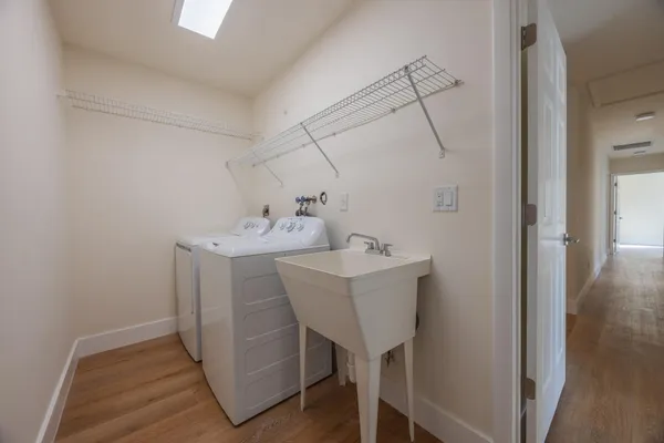 a utility room with cabinets washer and dryer