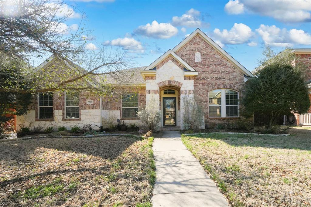 7519 Forest Ridge Trail Sachse, TX 75048 - Photo 1 of 35 a front view of a house with a yard