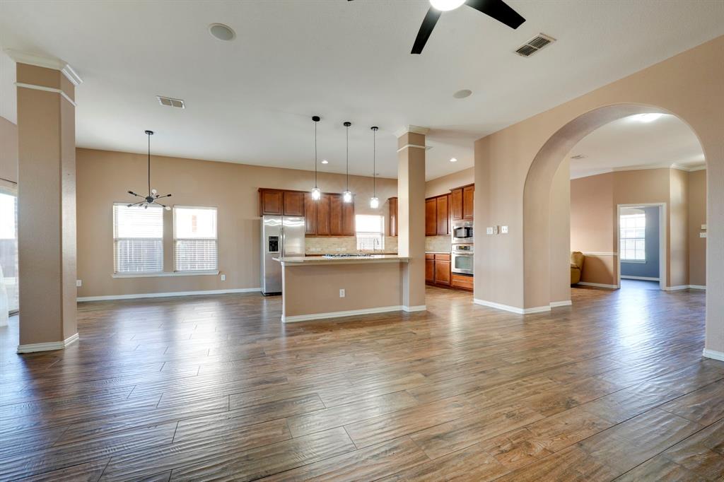 7519 Forest Ridge Trail Sachse, TX 75048 - Photo 12 of 35 a view of an empty room and kitchen with hardwood floor