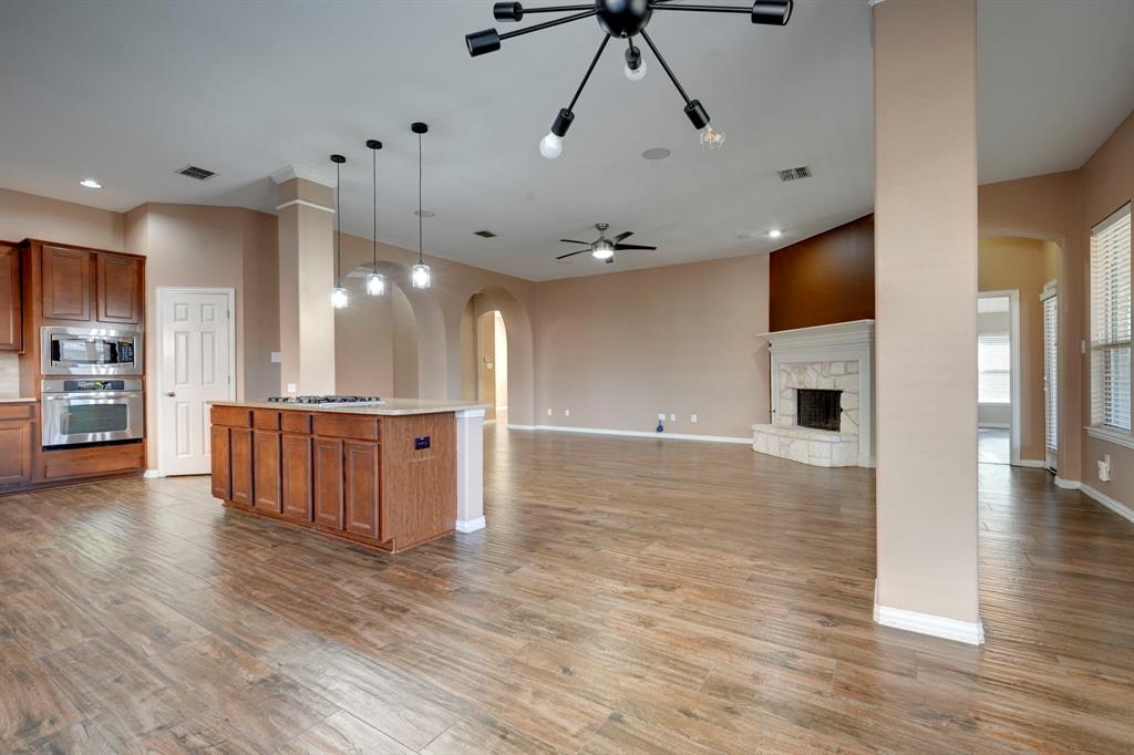 7519 Forest Ridge Trail Sachse, TX 75048 - Photo 14 of 35 a view of a room with kitchen island stainless steel appliances wooden floor and window
