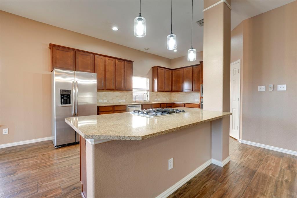 7519 Forest Ridge Trail Sachse, TX 75048 - Photo 16 of 35 a kitchen with stainless steel appliances granite countertop a sink stove and refrigerator