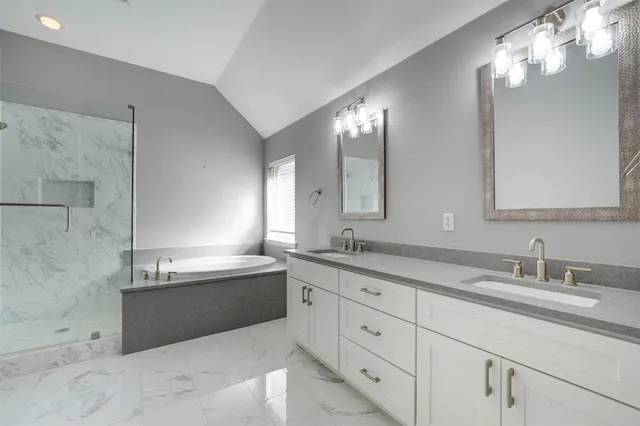 a bathroom with double vanity sink and a mirror