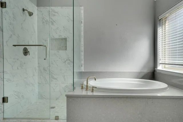 a bathroom with a granite countertop sink a toilet and shower