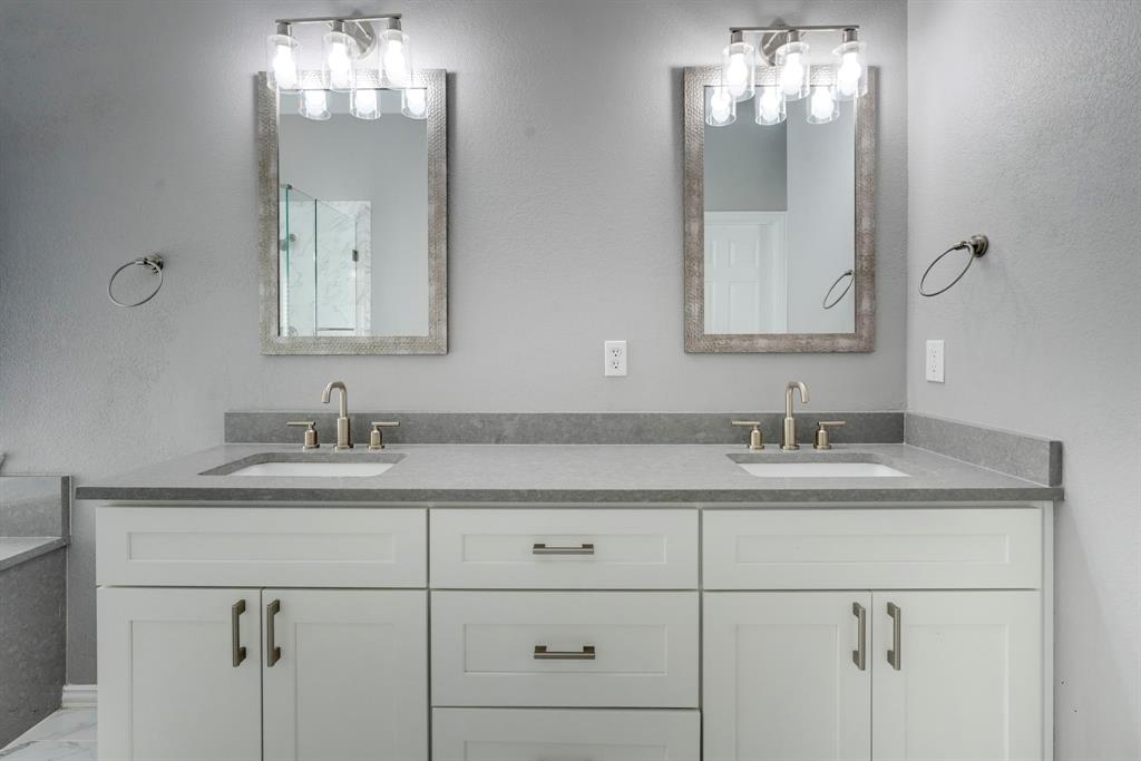 7519 Forest Ridge Trail Sachse, TX 75048 - Photo 27 of 35 a bathroom with double sink and a mirror