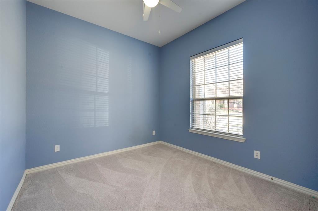 7519 Forest Ridge Trail Sachse, TX 75048 - Photo 30 of 35 an empty room with a window and a chandelier fan