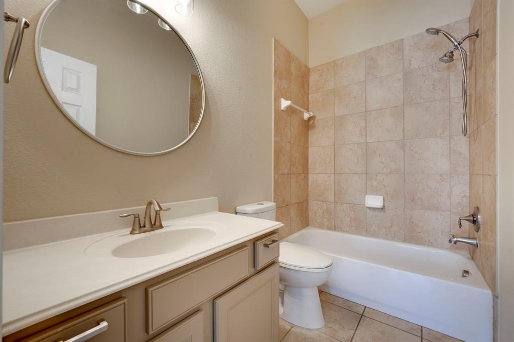 7519 Forest Ridge Trail Sachse, TX 75048 - Photo 31 of 35 a bathroom with a sink a toilet and a mirror