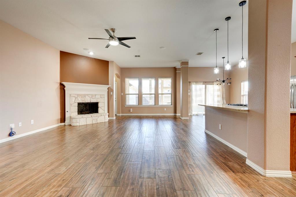 7519 Forest Ridge Trail Sachse, TX 75048 - Photo 9 of 35 a view of an empty room with wooden floor and a window