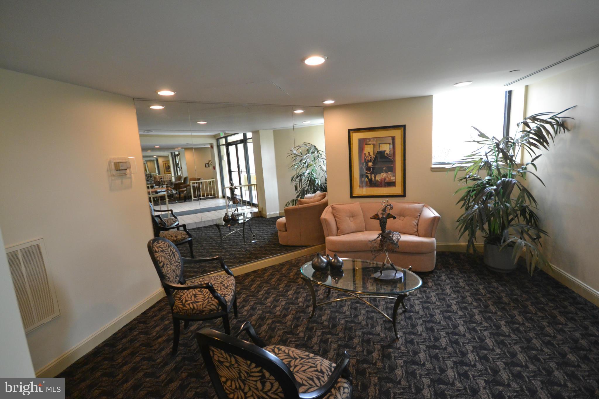 3011 Fallstaff Road, Unit 301A Baltimore, MD 21209 - Photo 3 of 25 a living room with furniture and a potted plant