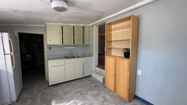 a kitchen with a refrigerator and cabinets
