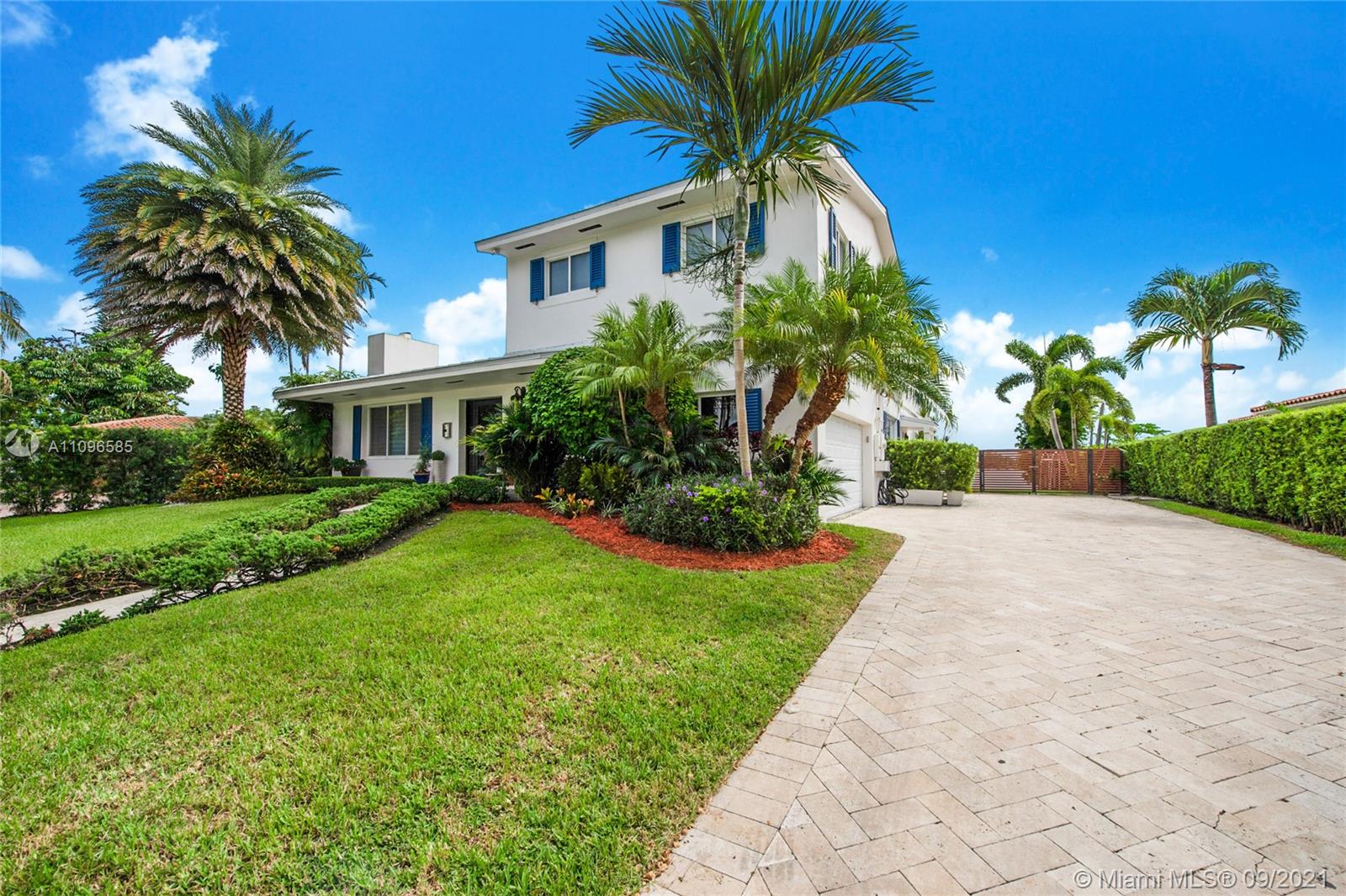 5131 Southwest 87th Avenue Miami, FL 33165 - Photo 2 of 24 a front view of a house with a yard and palm trees