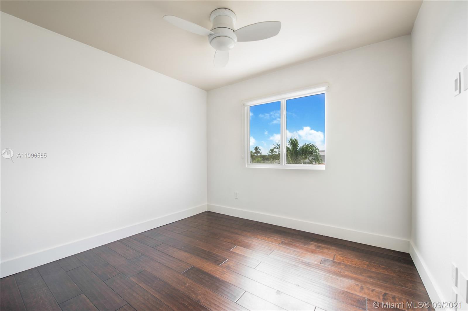 5131 Southwest 87th Avenue Miami, FL 33165 - Photo 14 of 24 wooden floor in an empty room with a window