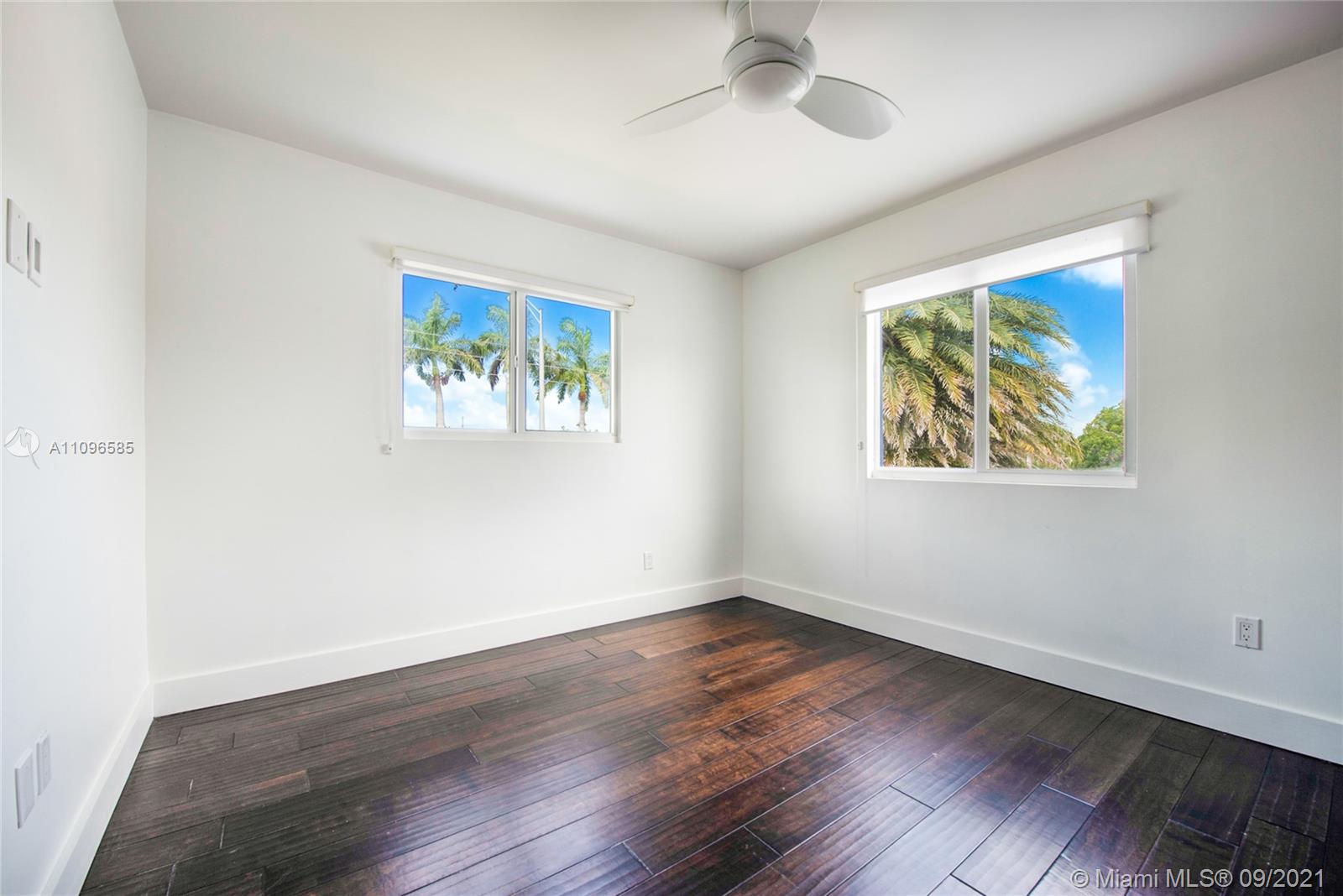 5131 Southwest 87th Avenue Miami, FL 33165 - Photo 15 of 24 a view of an empty room with wooden floor and a window