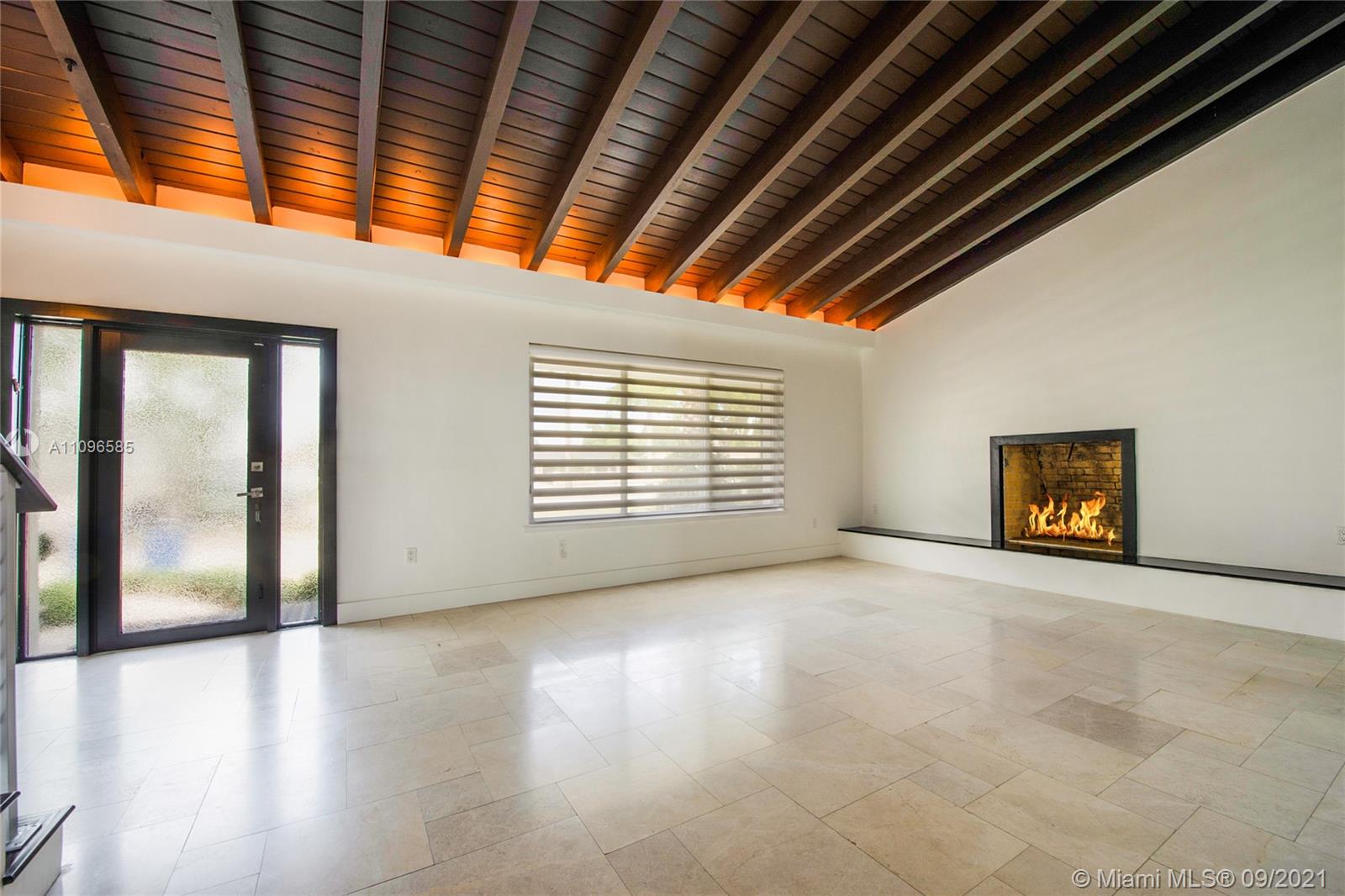5131 Southwest 87th Avenue Miami, FL 33165 - Photo 6 of 24 a view of an empty room with a window and wooden floor