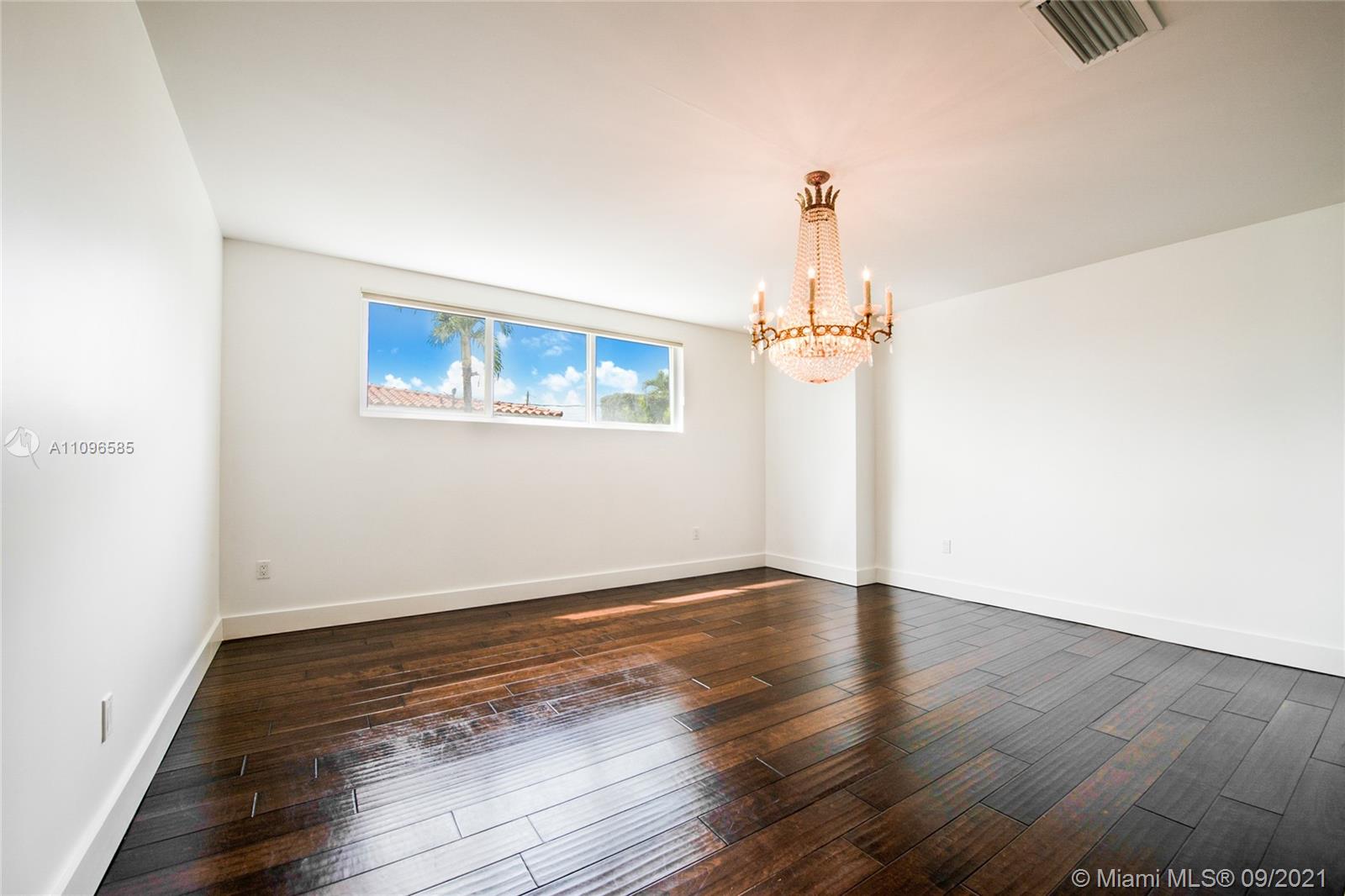 5131 Southwest 87th Avenue Miami, FL 33165 - Photo 7 of 24 an empty room with wooden floor and windows