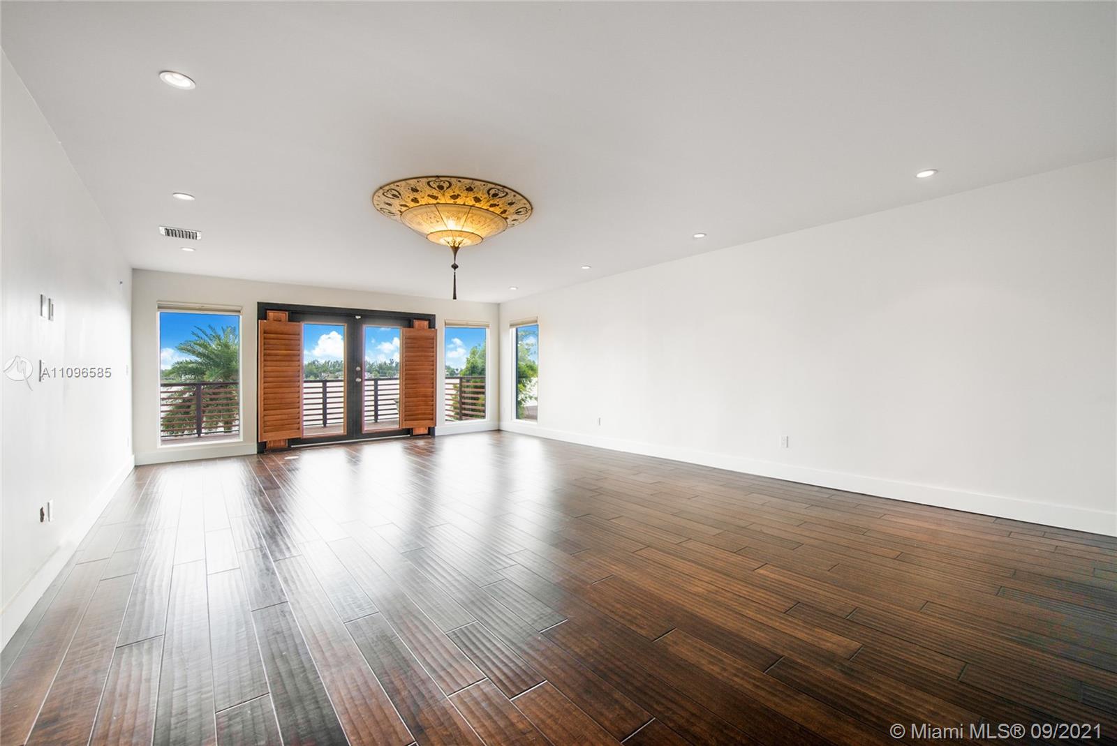 5131 Southwest 87th Avenue Miami, FL 33165 - Photo 10 of 24 a view of an empty room with wooden floor and a window