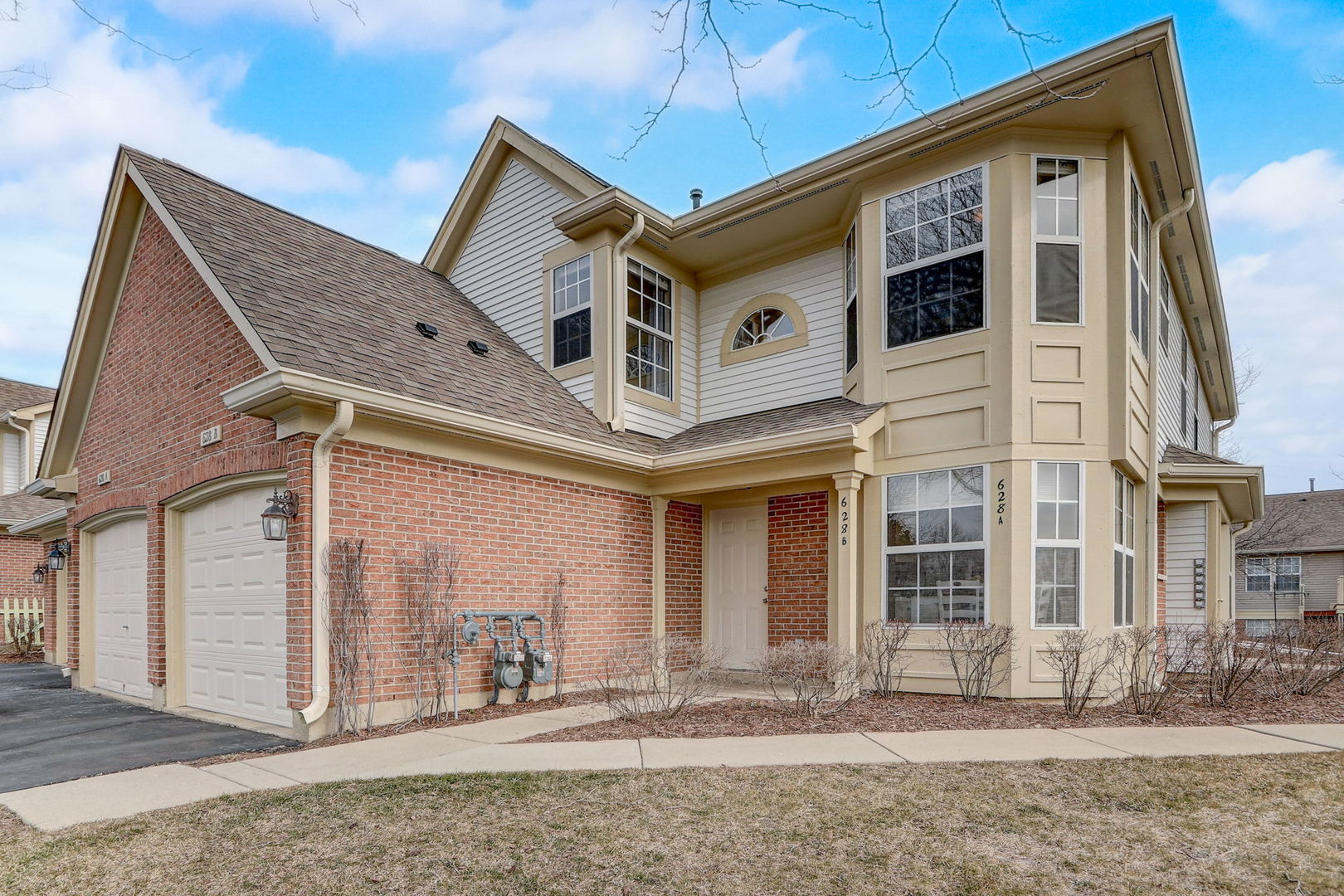 a view of a white house with large windows