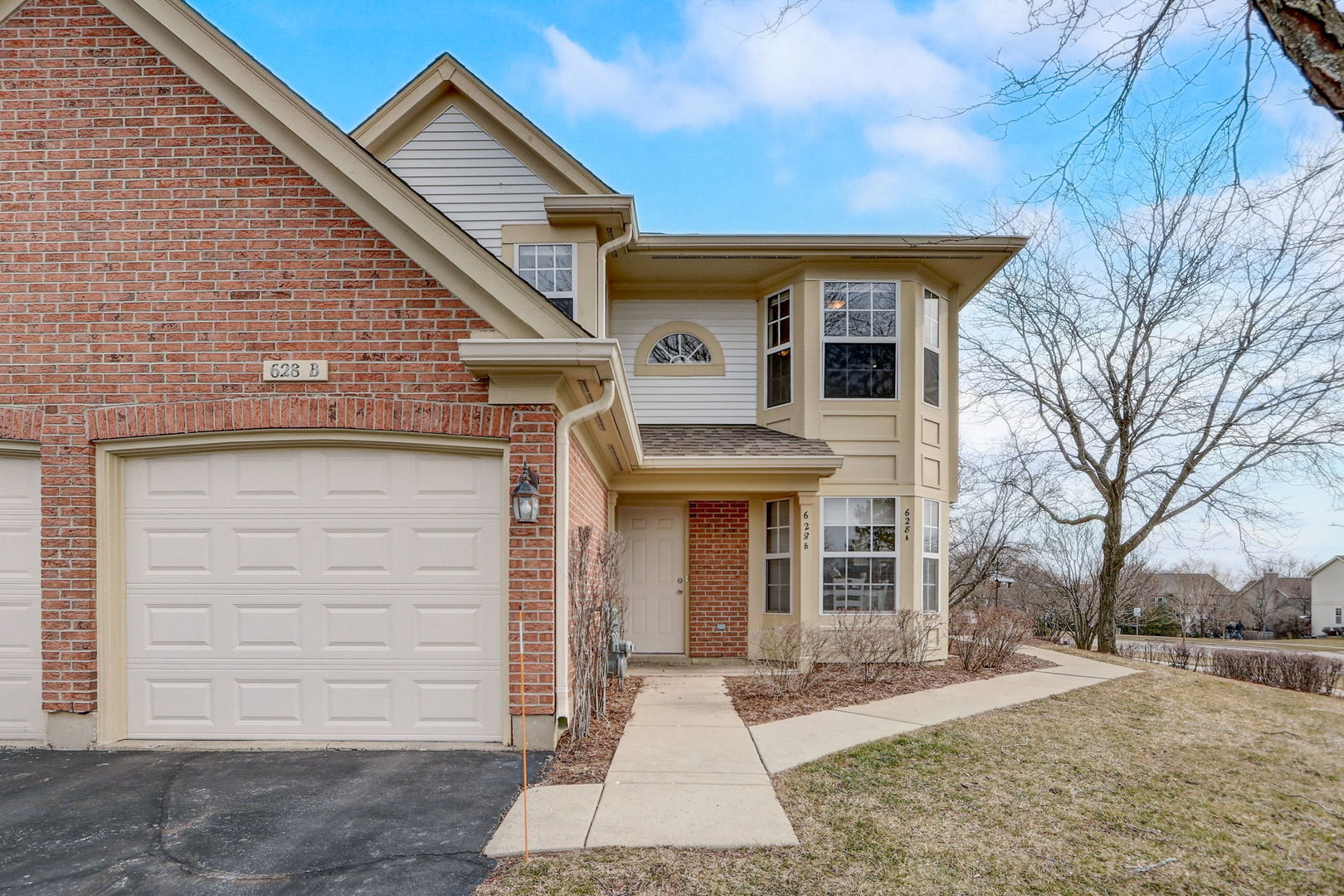 628 Village Road, Unit B Crystal Lake, IL 60014 - Photo 2 of 33 a front view of a house with a yard