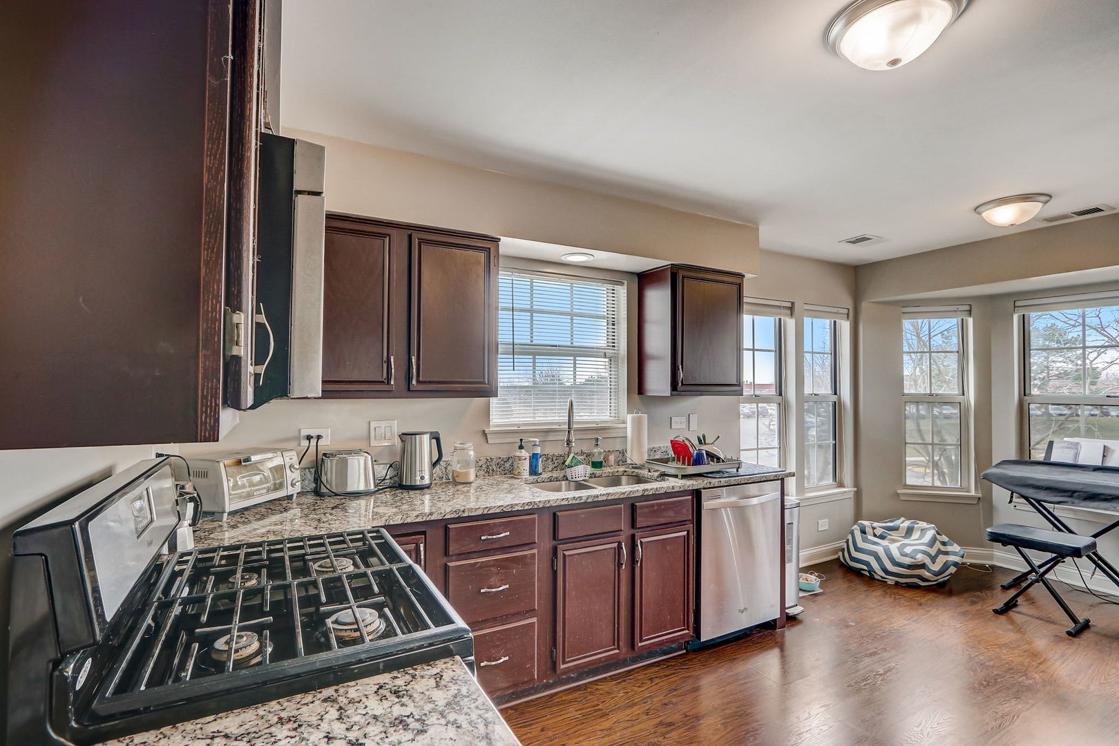 628 Village Road, Unit B Crystal Lake, IL 60014 - Photo 8 of 33 a kitchen that has a sink and a stove
