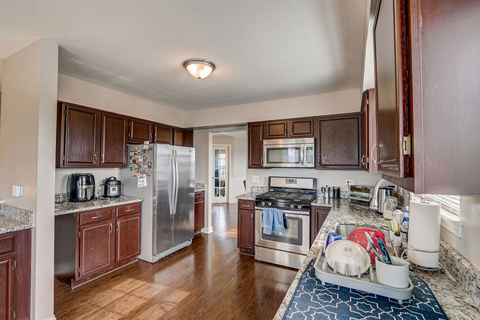 628 Village Road, Unit B Crystal Lake, IL 60014 - Photo 10 of 33 a kitchen with stainless steel appliances a stove a sink cabinets and a refrigerator