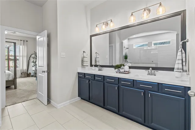 a bathroom with a double vanity sink and a mirror