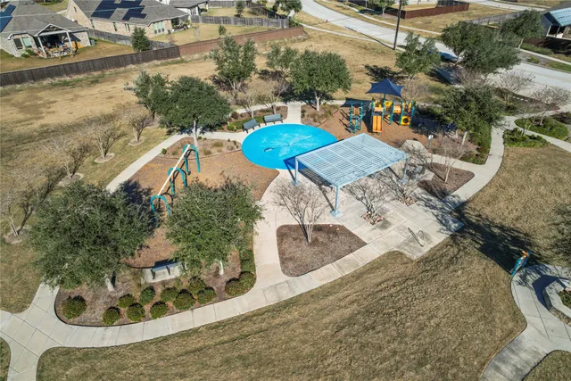 an aerial view of a house with a swimming pool