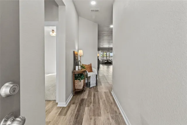 a view of hallway with wooden floor
