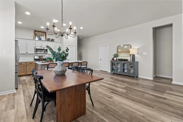 a view of a dining room with furniture and wooden floor