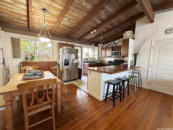 a kitchen with stainless steel appliances wooden floors stove and refrigerator