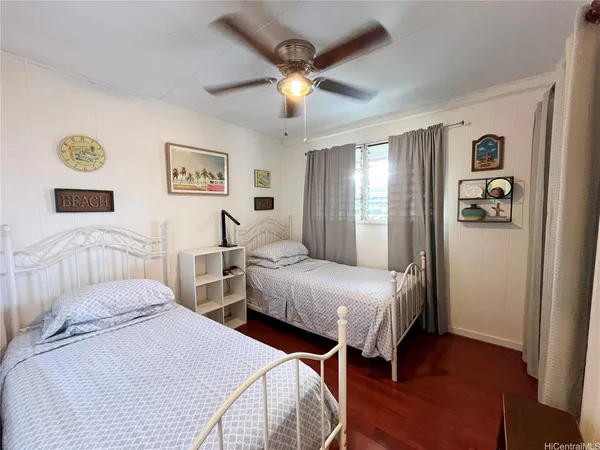 a bedroom with two beds and a window